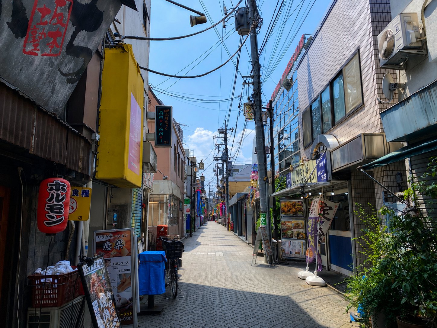 A narrow alley in Asagaya lined with izakaya lanterns and hand-painted signs