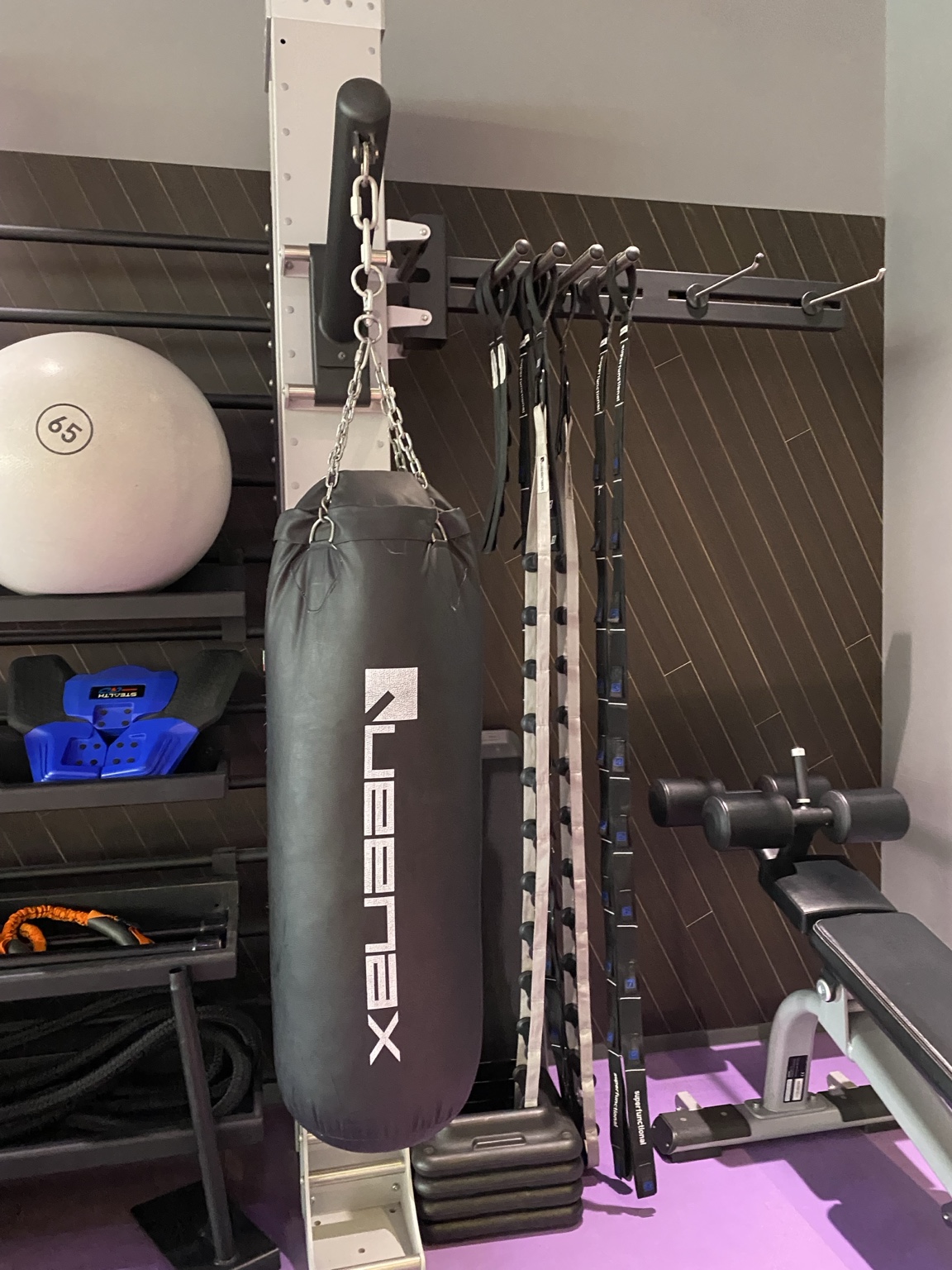 Punching bag and resistance bands set up beside the stretching area