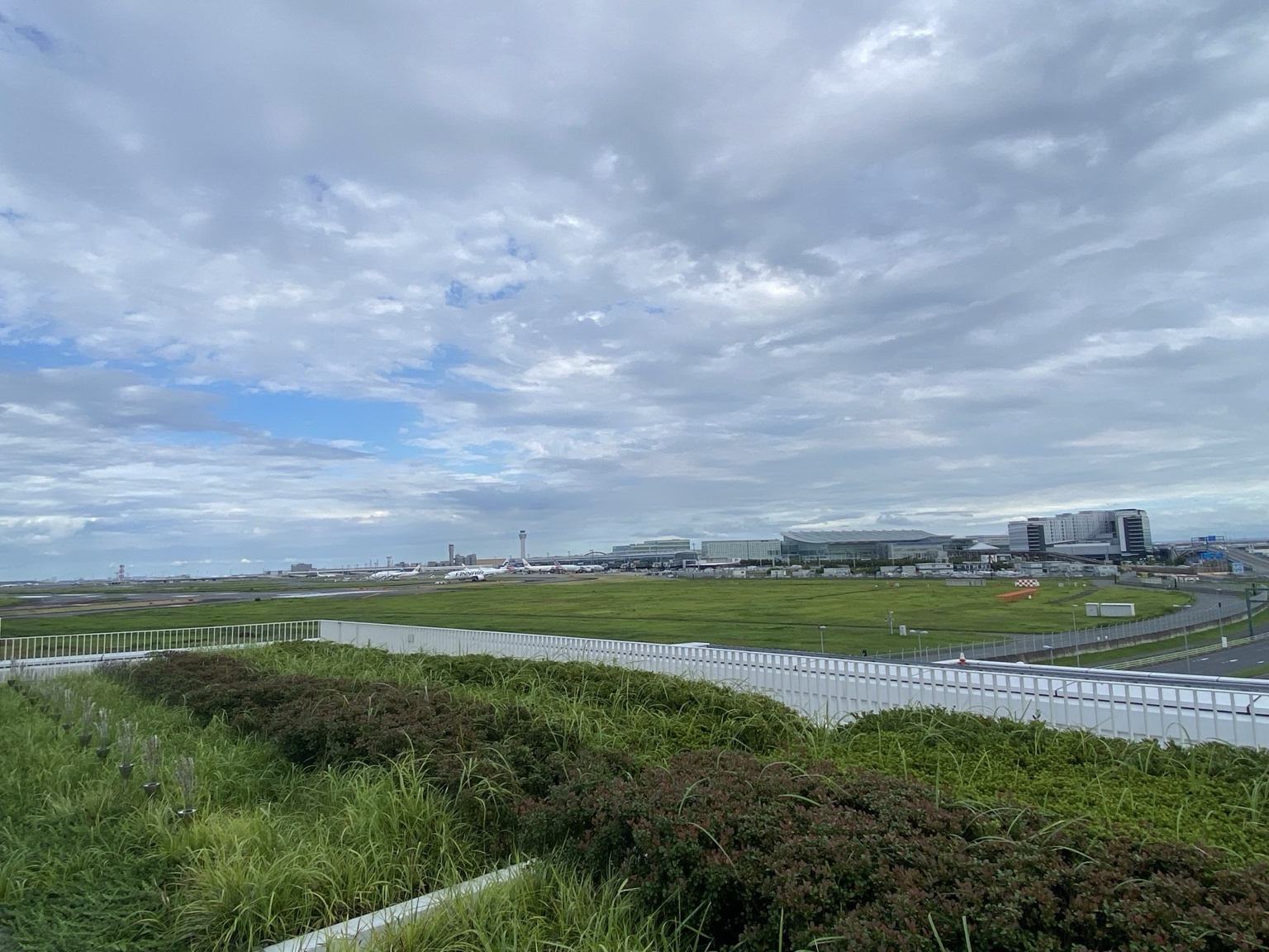 View of Haneda Airport runway and an aircraft from the Haneda Innovation City deck